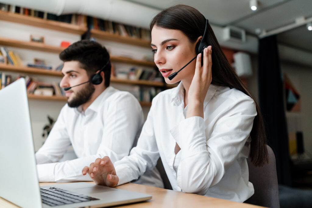 beautiful woman works in call center with headset answering client phone calls